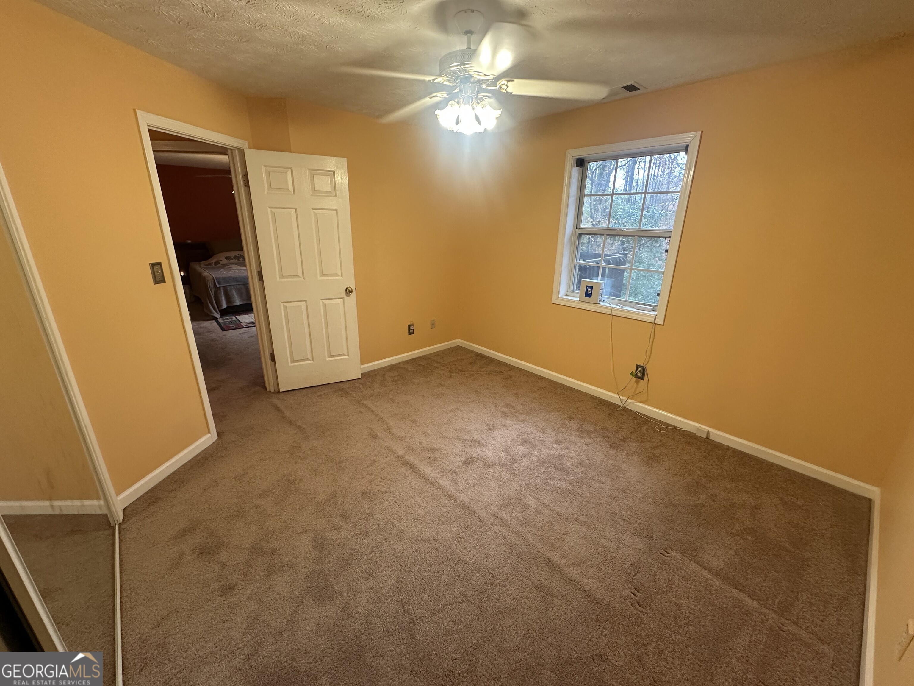 565 Patillo Road Stockbridge, GA 30281 - Photo 9 of 31 a view of empty room with window and ceiling fan