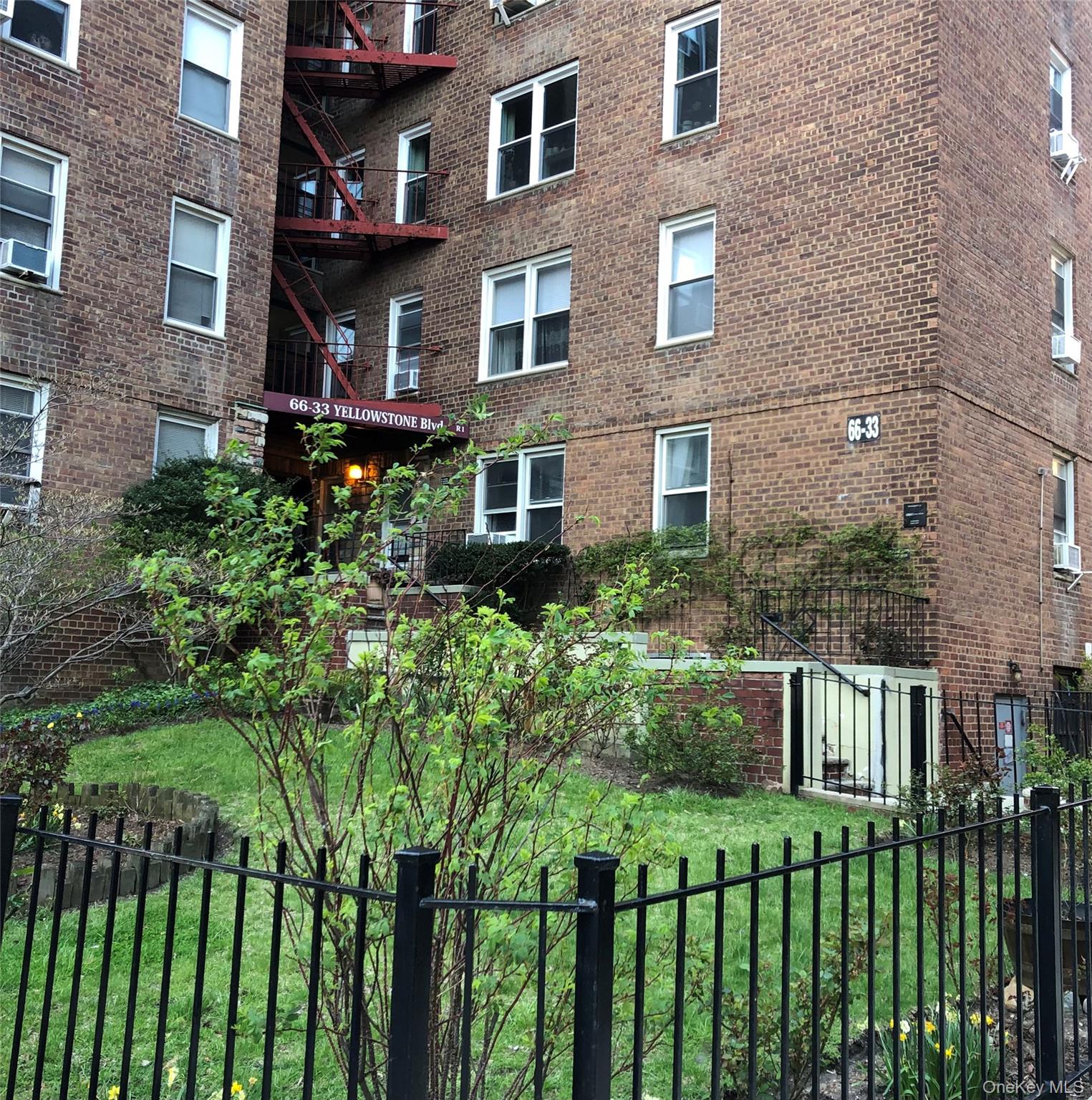 66-33 Yellowstone Boulevard, Unit 2B Queens, NY 11375 - Photo 13 of 13 a front view of a house with a garden
