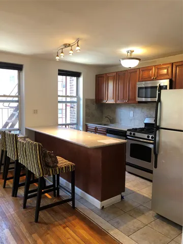 a kitchen with a stove a sink and a refrigerator