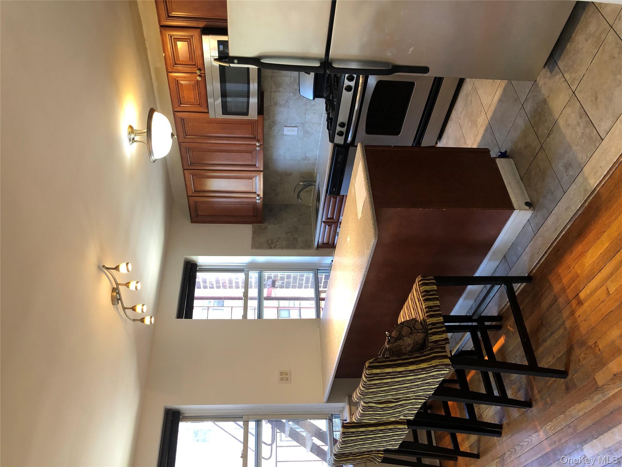 66-33 Yellowstone Boulevard, Unit 2B Queens, NY 11375 - Photo 3 of 13 a kitchen with a stove a sink and a refrigerator