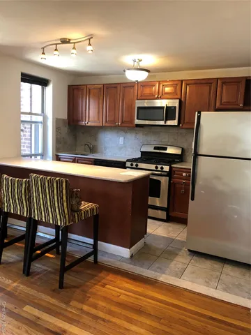 a kitchen with a sink appliances and cabinets