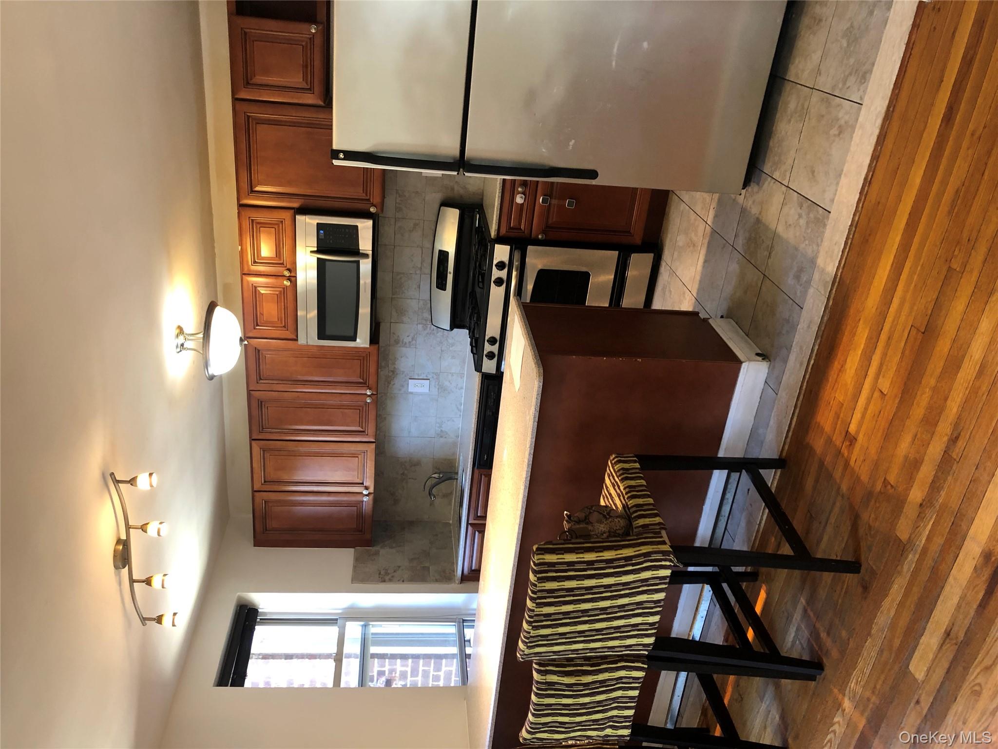 66-33 Yellowstone Boulevard, Unit 2B Queens, NY 11375 - Photo 4 of 13 a kitchen with a sink appliances and cabinets