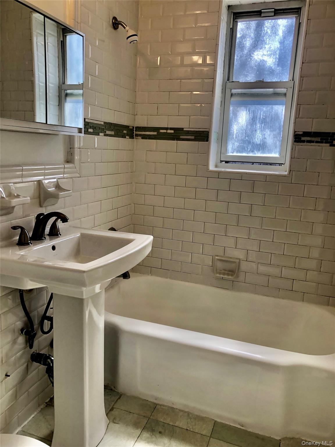 66-33 Yellowstone Boulevard, Unit 2B Queens, NY 11375 - Photo 7 of 13 a bathroom with a sink and a bathtub