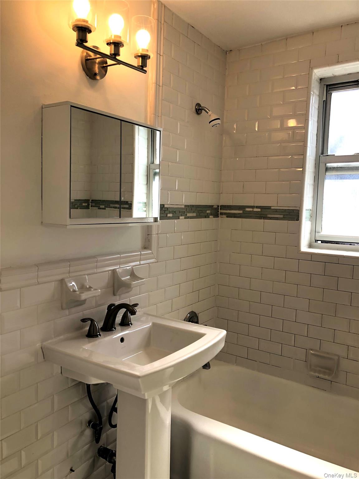 66-33 Yellowstone Boulevard, Unit 2B Queens, NY 11375 - Photo 8 of 13 a bathroom with a sink a toilet and window