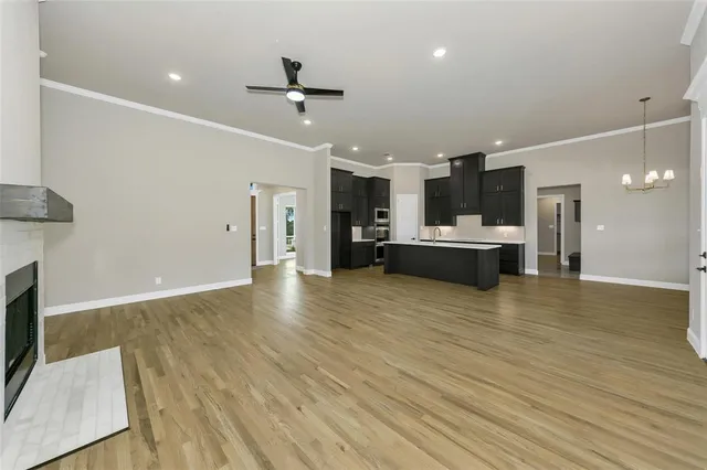 a kitchen with a sink a counter top space stainless steel appliances and cabinets