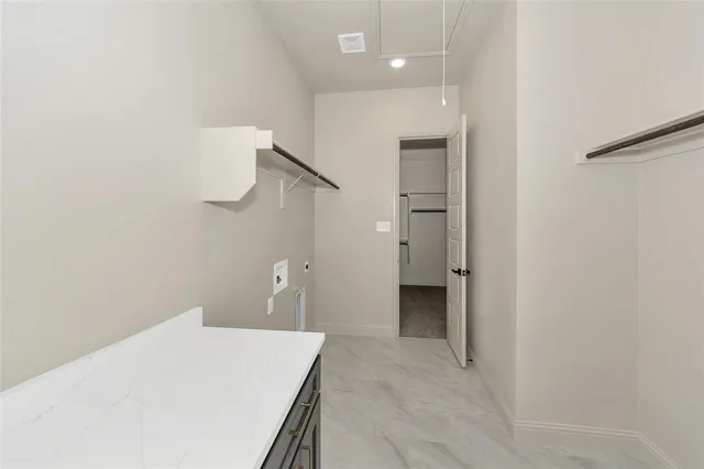 a view of a kitchen from a hallway