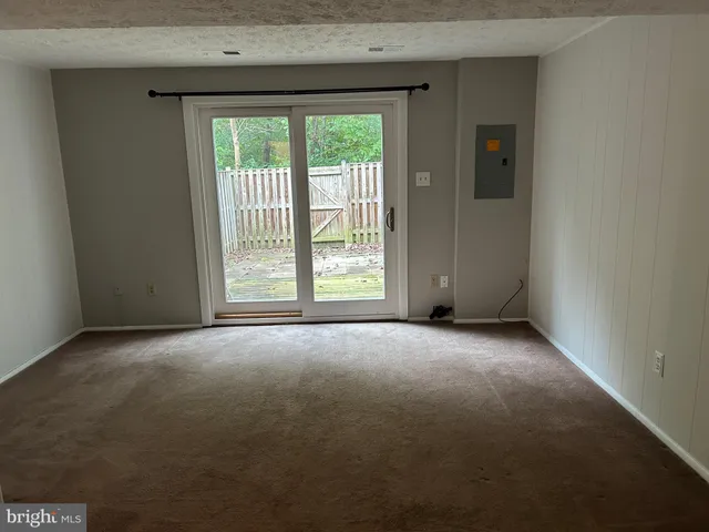 a view of empty room with floor to ceiling window