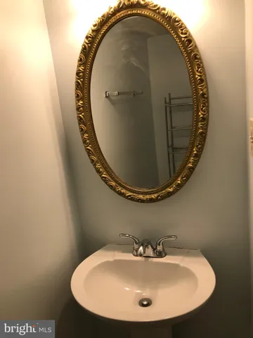 a bathroom with a sink and mirror