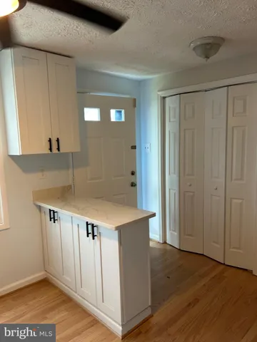 a view of kitchen with furniture and wooden floor