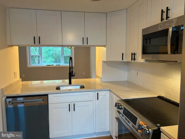 a kitchen with a sink and cabinets