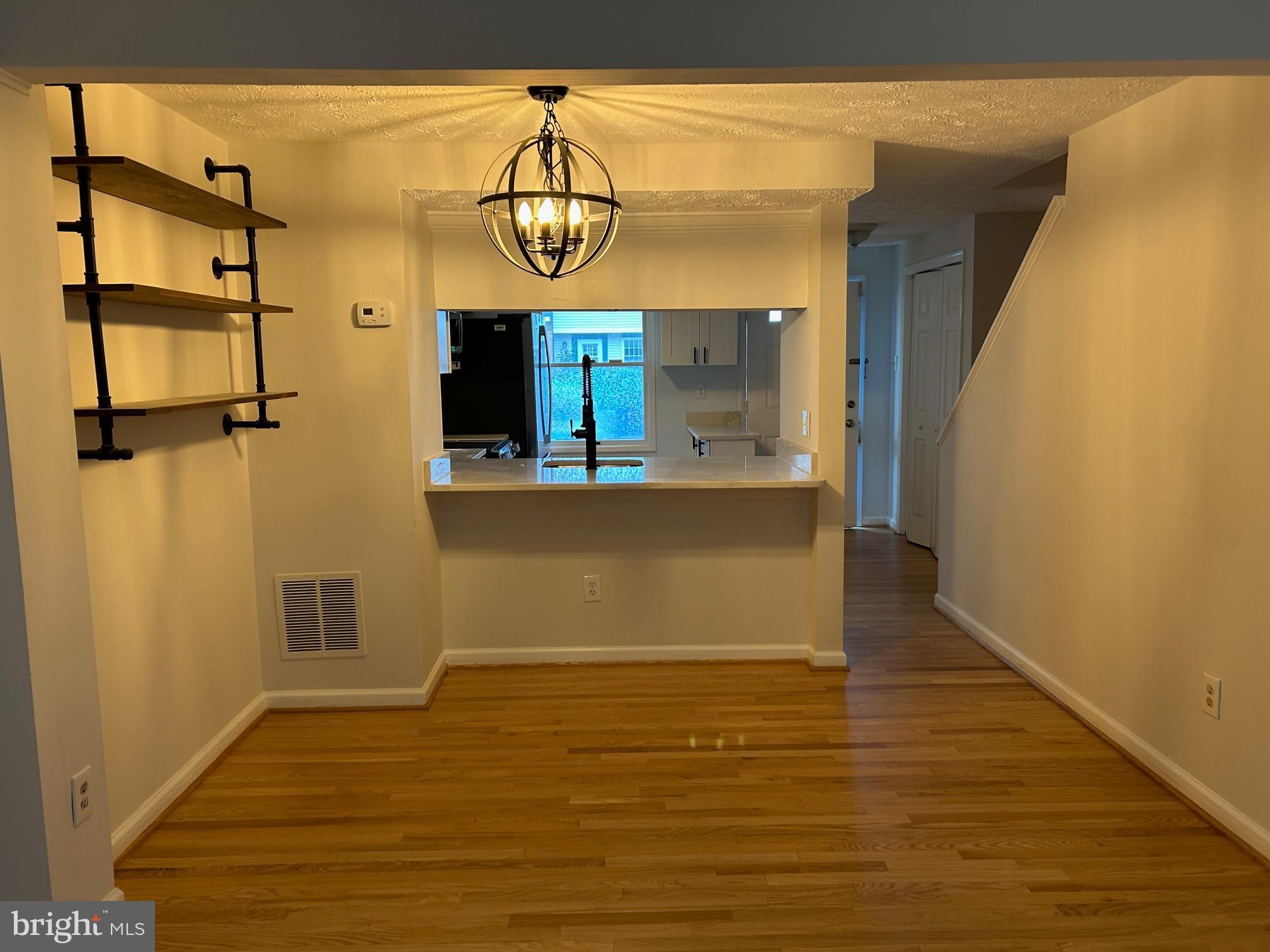 8317 Brookvale Court Springfield, VA 22153 - Photo 7 of 15 a view of a room with wooden floor and windows
