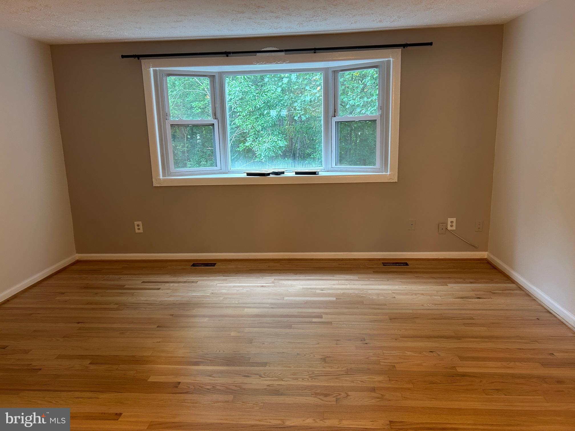 8317 Brookvale Court Springfield, VA 22153 - Photo 8 of 15 a view of a room with wooden floor and a window