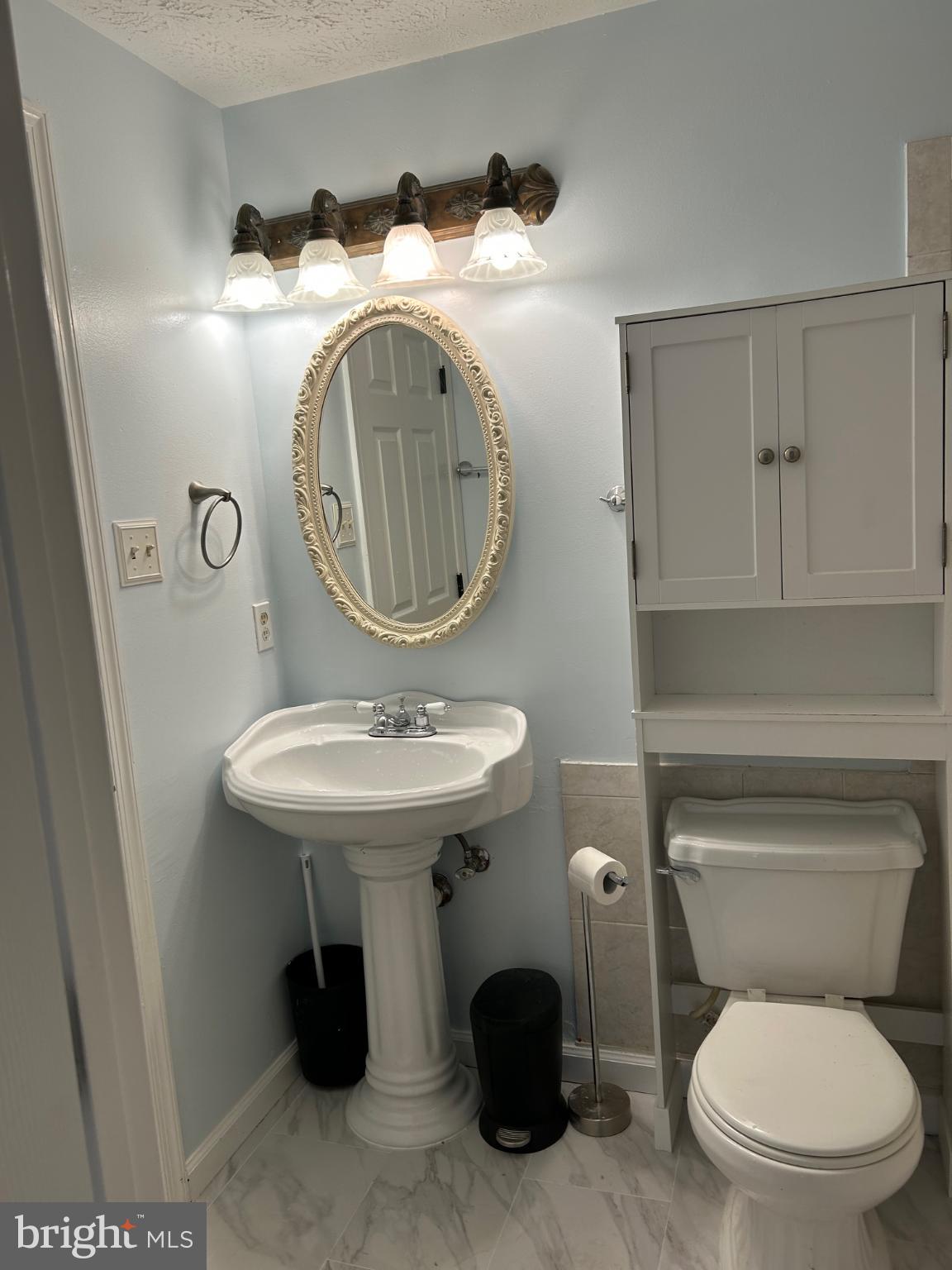 8317 Brookvale Court Springfield, VA 22153 - Photo 10 of 15 a bathroom with a toilet sink and mirror