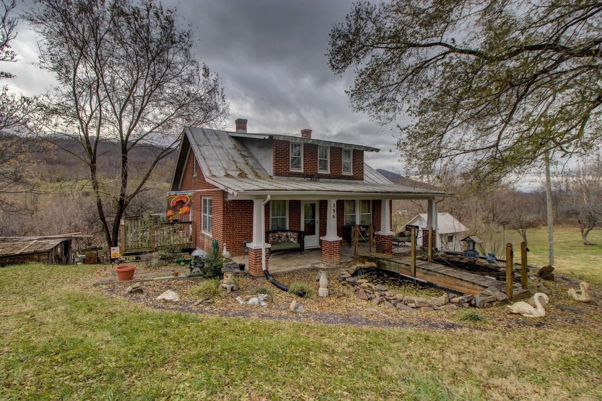 296 Archway Road Blue Ridge, VA 24064 - Photo 2 of 28 a front view of a house with garden