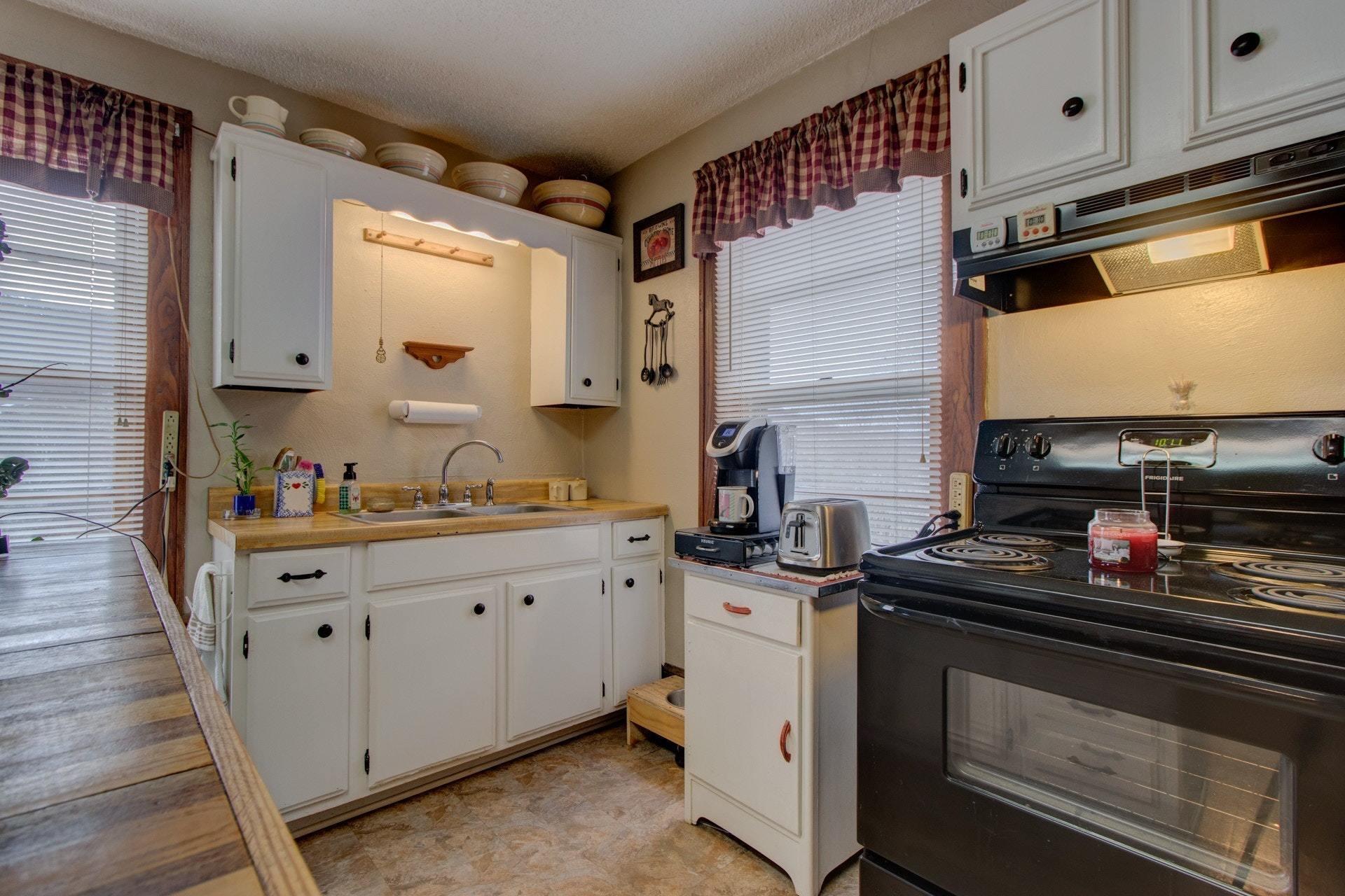 296 Archway Road Blue Ridge, VA 24064 - Photo 11 of 28 a kitchen with stainless steel appliances a sink stove and cabinets