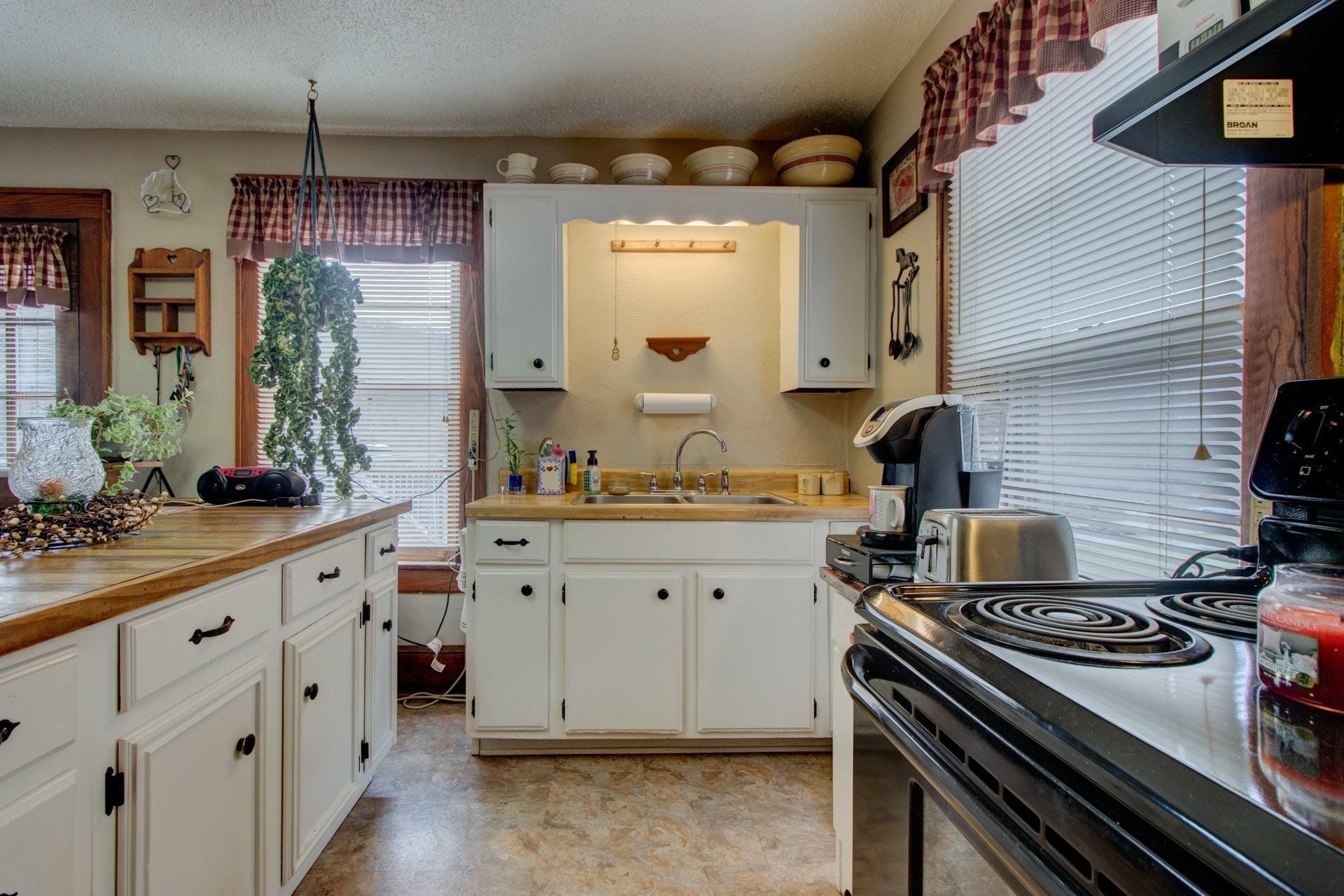 296 Archway Road Blue Ridge, VA 24064 - Photo 12 of 28 a kitchen with granite countertop a stove and a sink