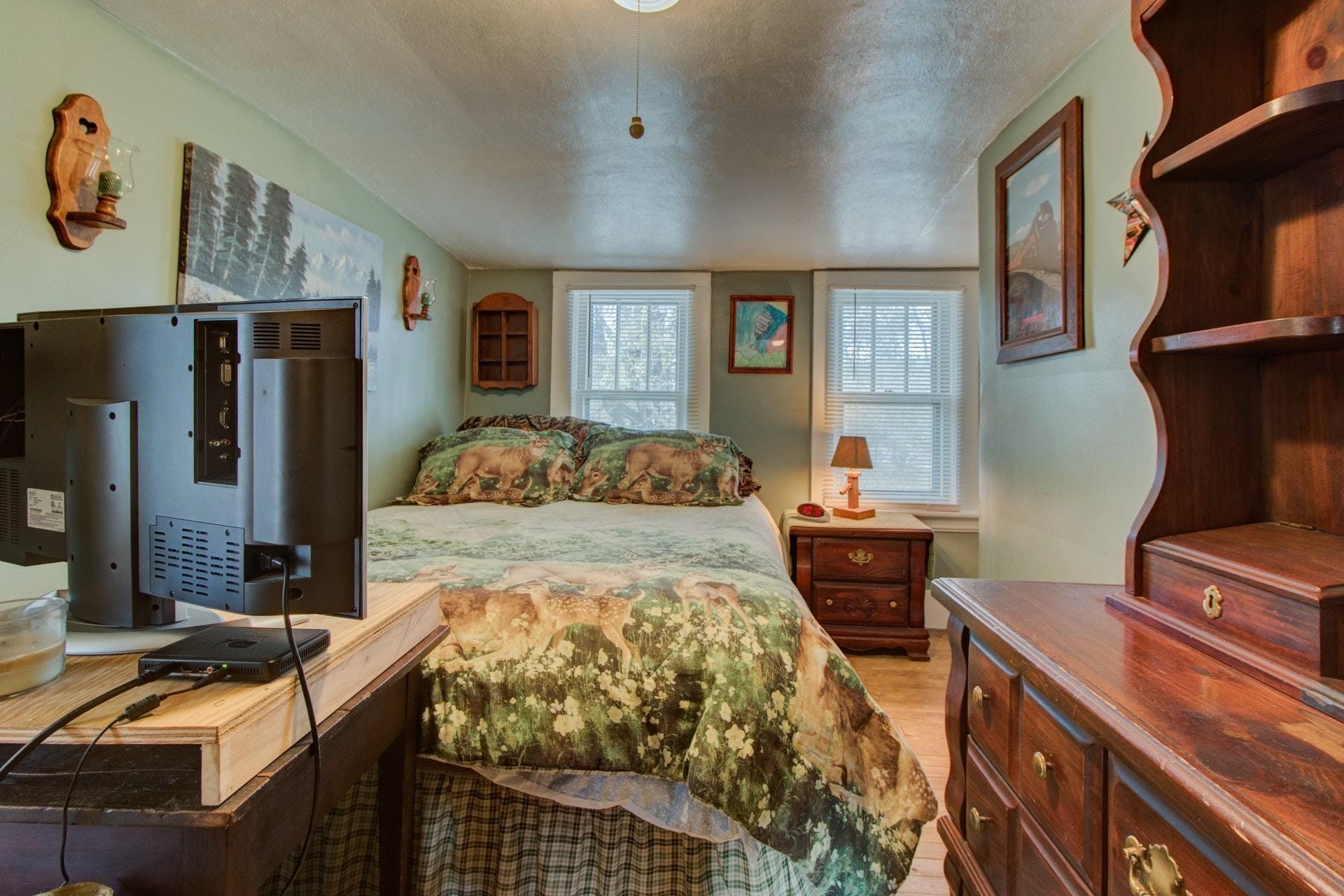 296 Archway Road Blue Ridge, VA 24064 - Photo 16 of 28 a bedroom with a bed and wooden floor
