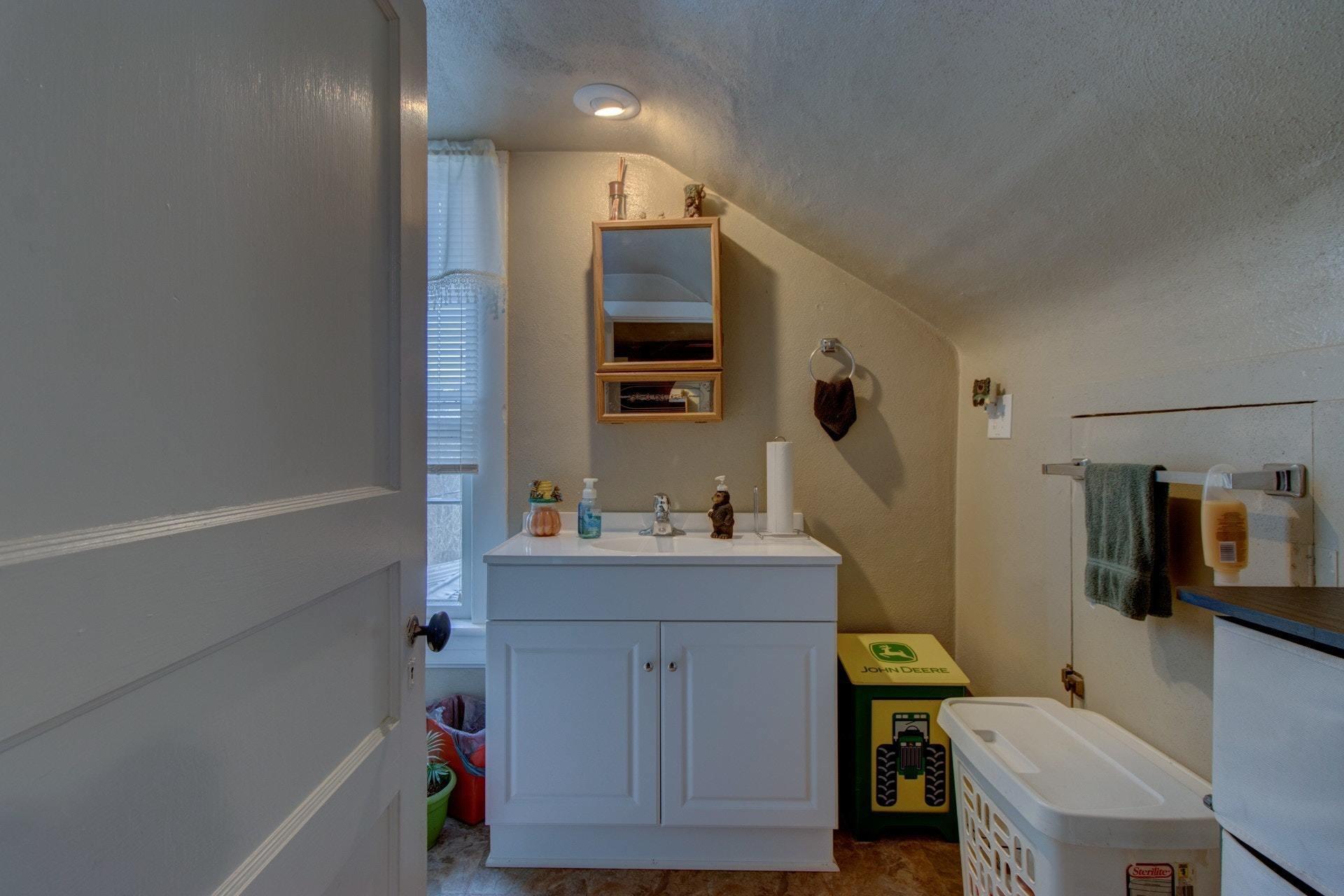 296 Archway Road Blue Ridge, VA 24064 - Photo 17 of 28 a bathroom with a sink a toilet a mirror and shower