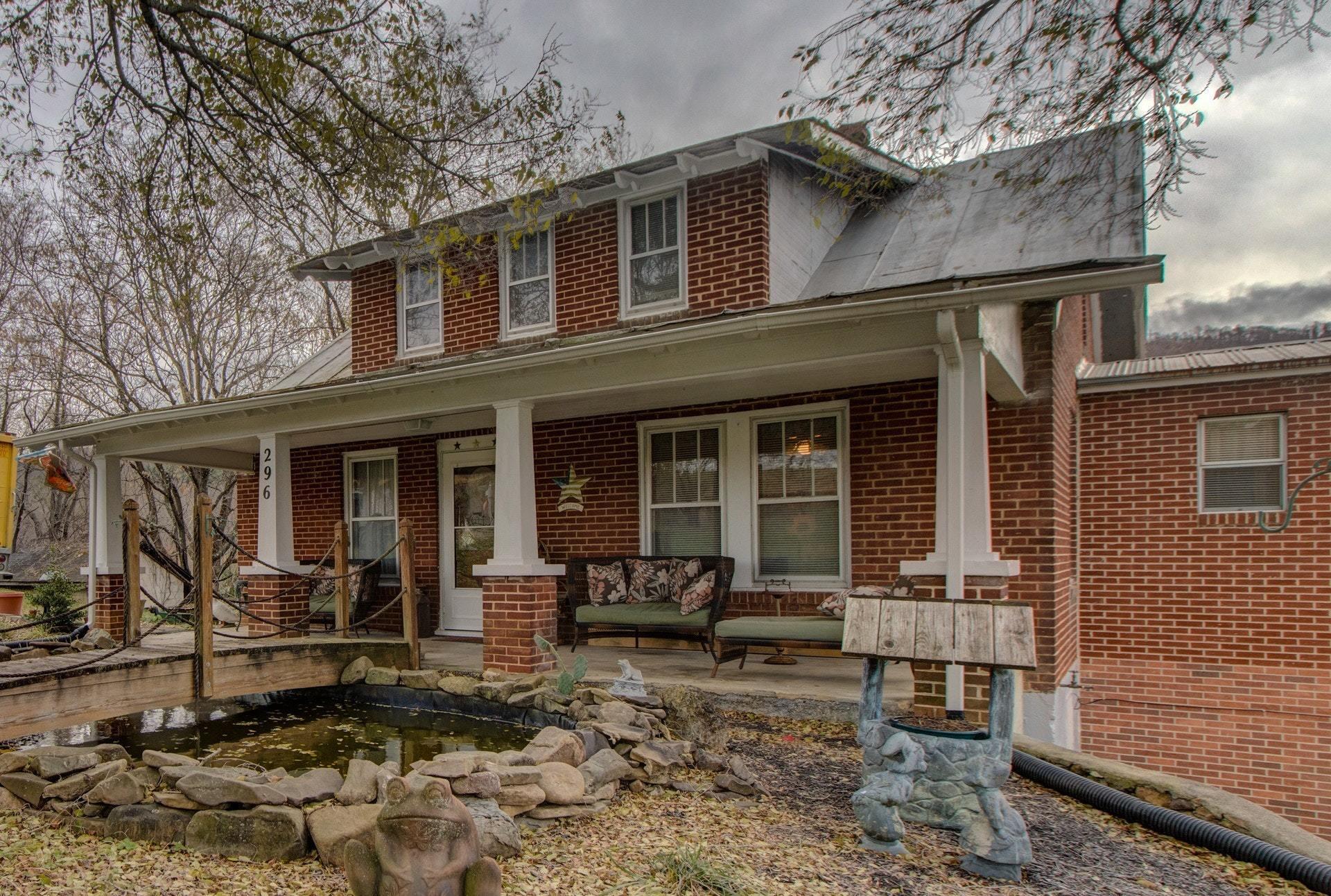 296 Archway Road Blue Ridge, VA 24064 - Photo 3 of 28 a view of a house with a yard chairs and floor to ceiling window