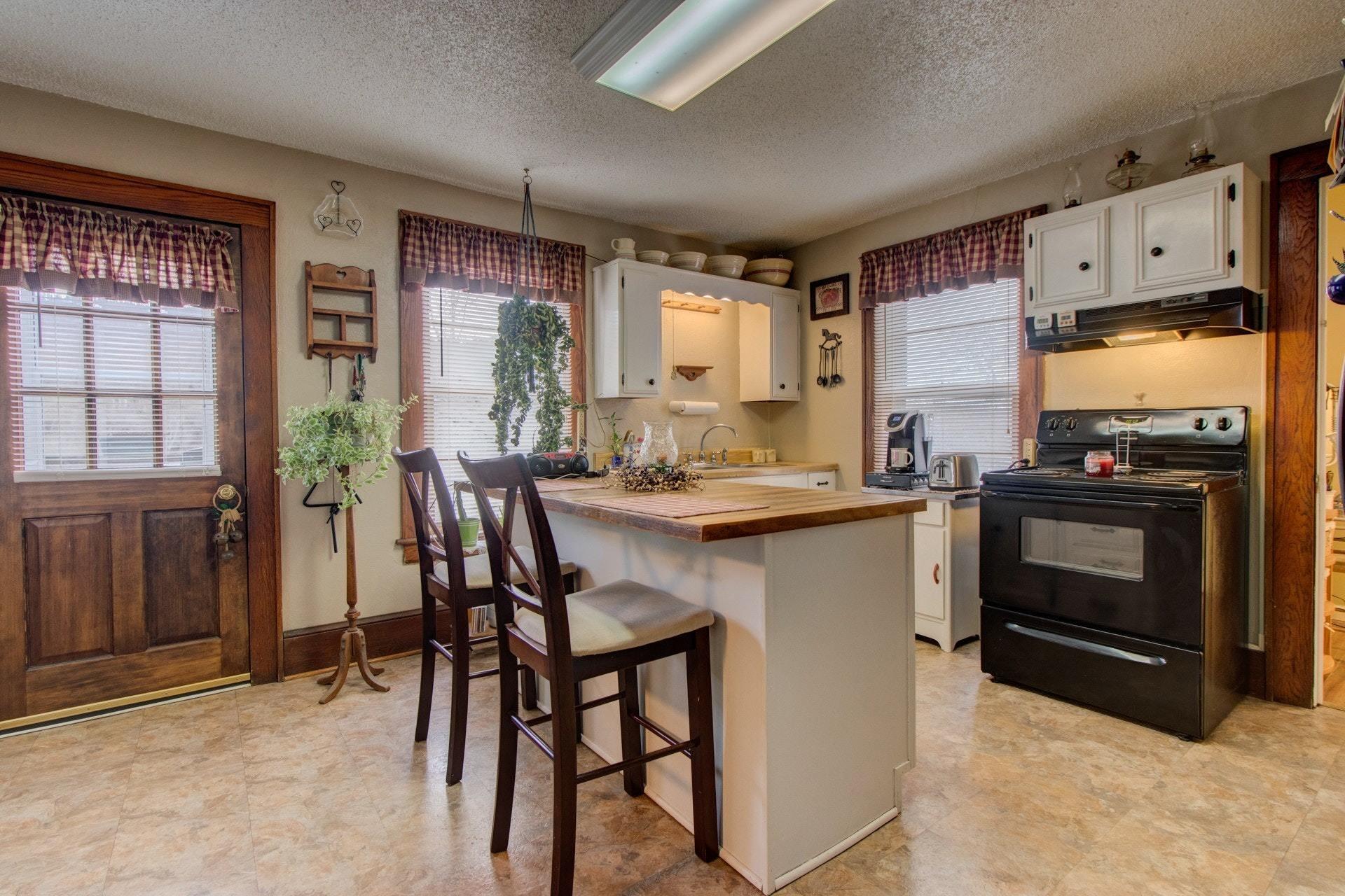 296 Archway Road Blue Ridge, VA 24064 - Photo 10 of 28 a kitchen with a table chairs refrigerator and cabinets