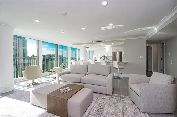 a kitchen with stainless steel appliances granite countertop a stove top oven a sink dishwasher a dining table and chairs with wooden floor