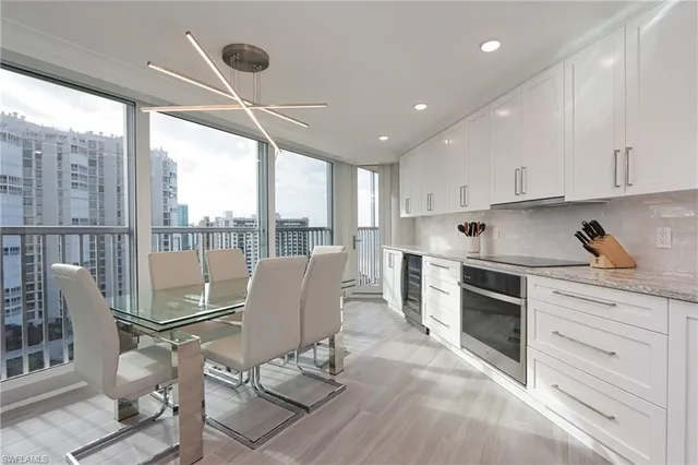 a large kitchen with kitchen island a dining table and chairs