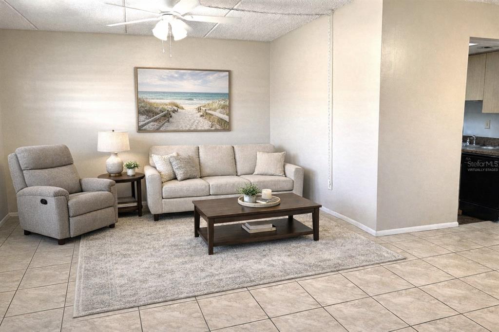 12760 Indian Rocks Road, Unit 562 Largo, FL 33774 - Photo 6 of 22 a living room with furniture and a wall painting