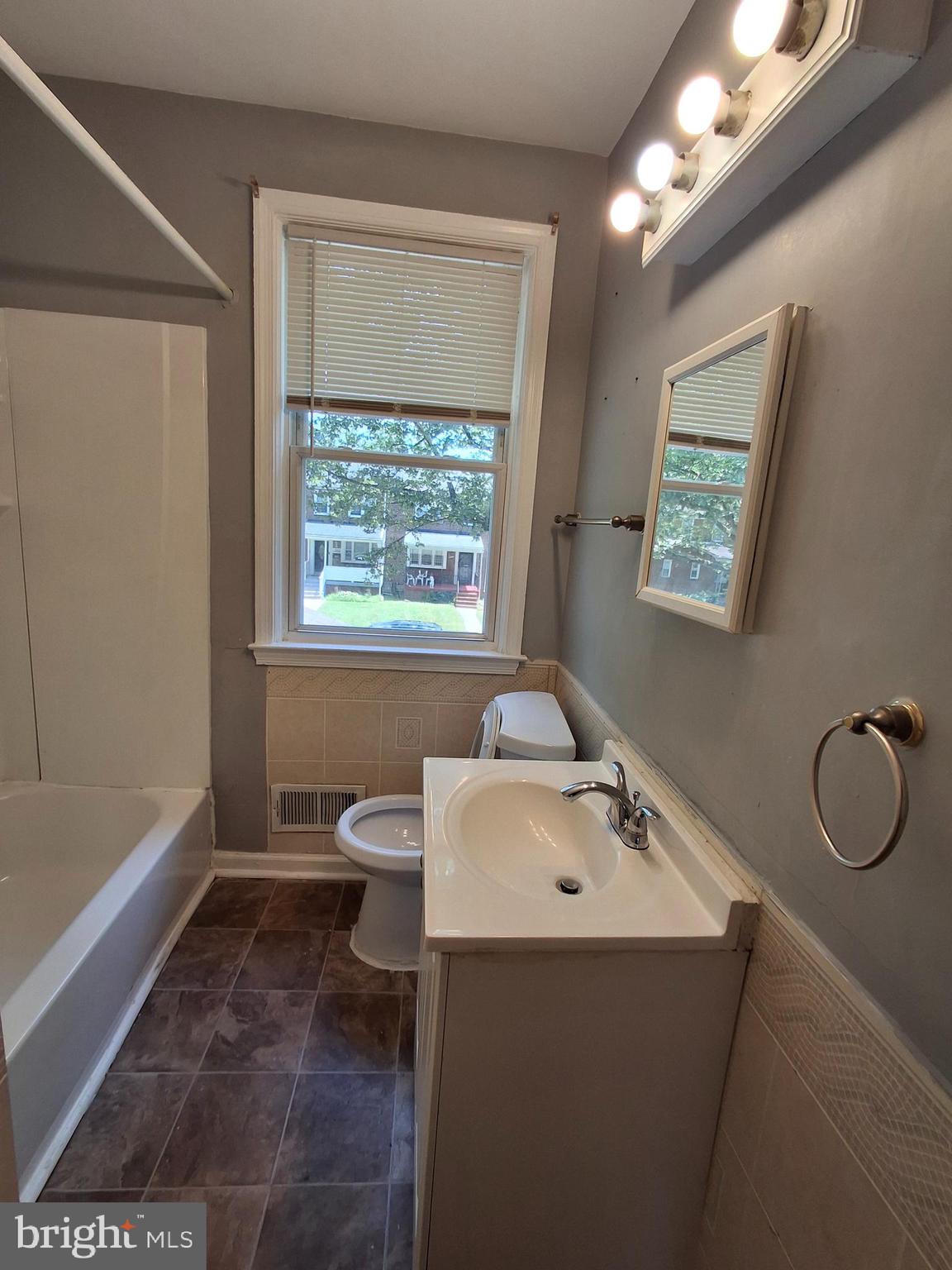 3906 Rosecrest Avenue Baltimore, MD 21215 - Photo 11 of 23 a bathroom with a sink toilet and shower