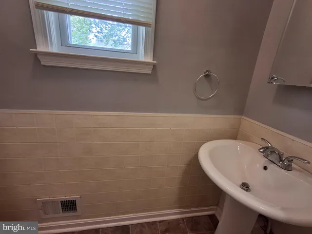 a bathroom with a sink and a window