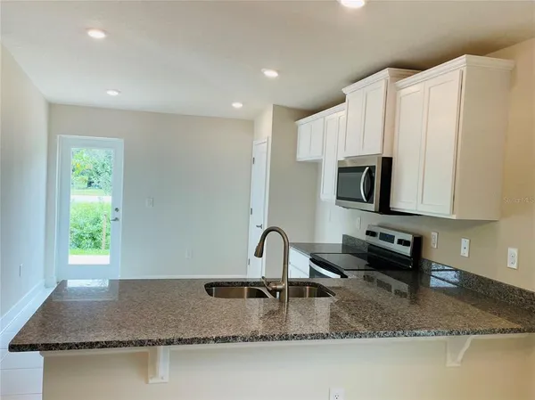 a kitchen with sink a window and a counter top space