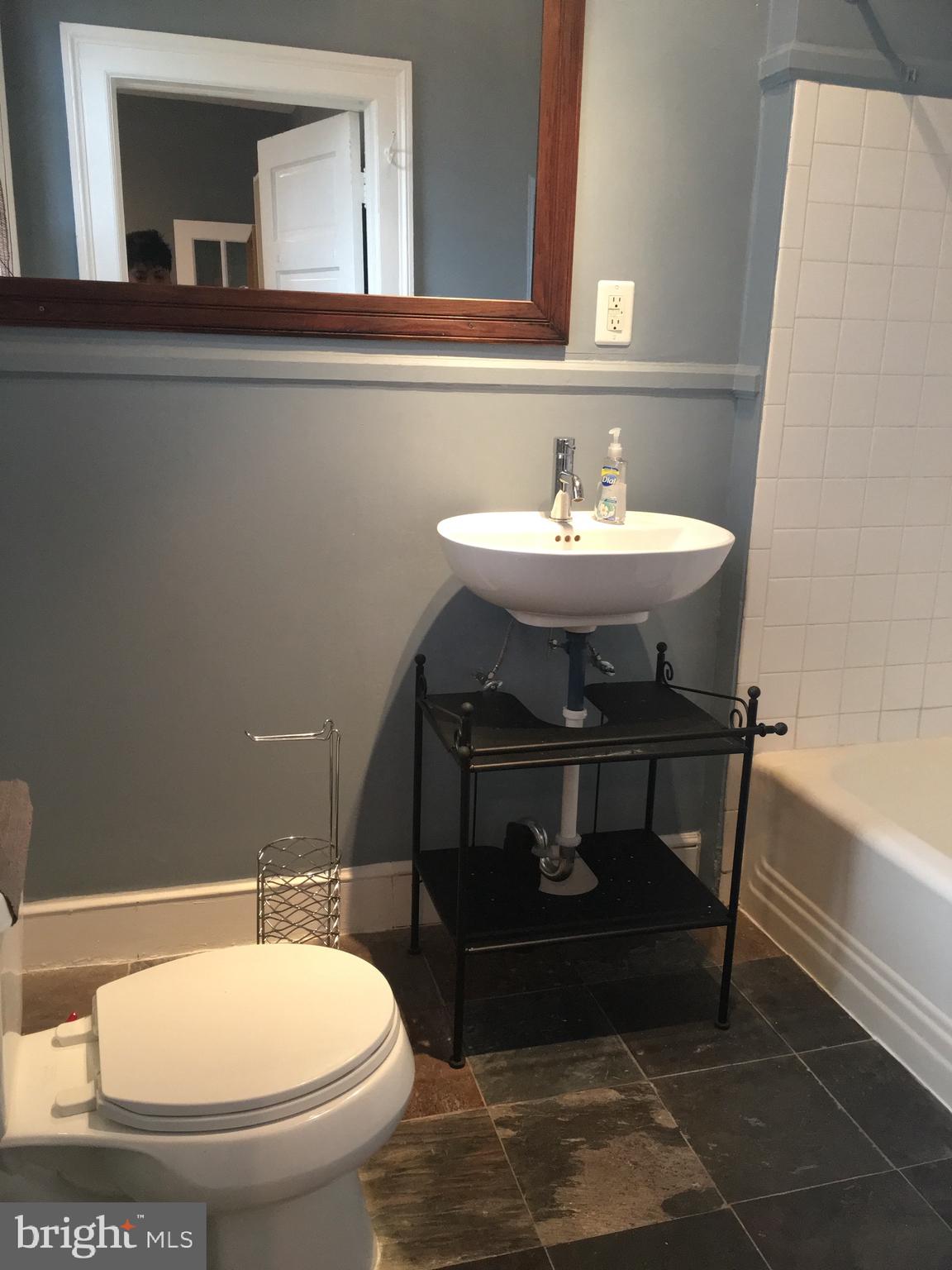 3704 Chatham Road Baltimore, MD 21215 - Photo 13 of 28 a bathroom with a sink and a mirror