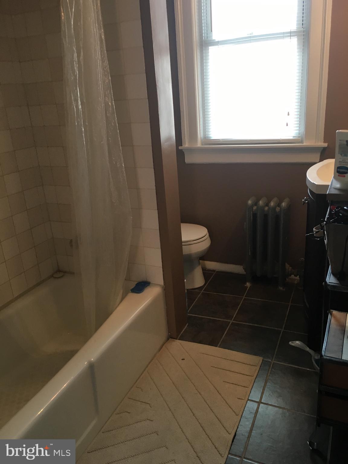 3704 Chatham Road Baltimore, MD 21215 - Photo 17 of 28 a bathroom with a sink a toilet a window and shower