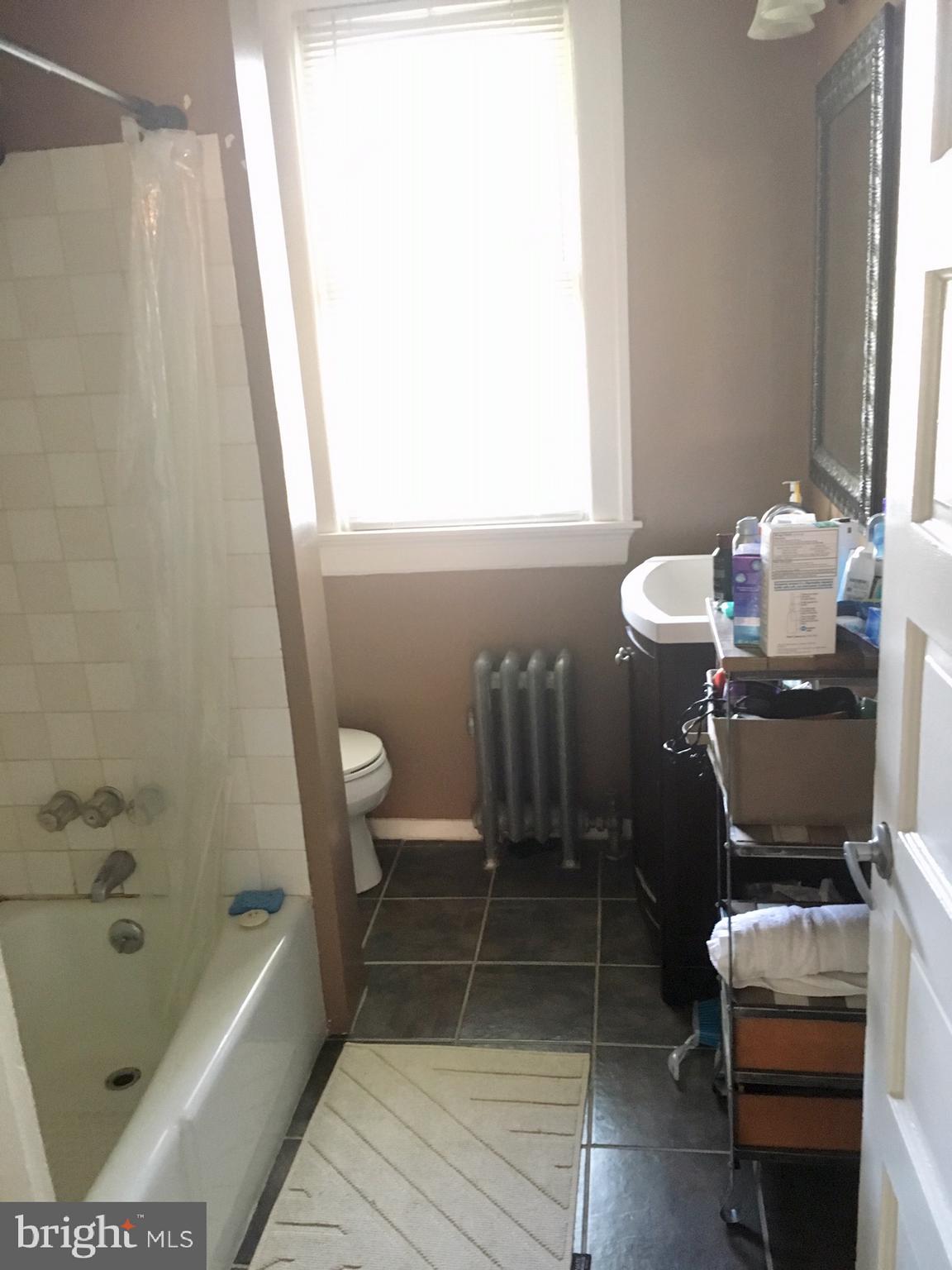 3704 Chatham Road Baltimore, MD 21215 - Photo 19 of 28 a bathroom with a tub sink and toilet