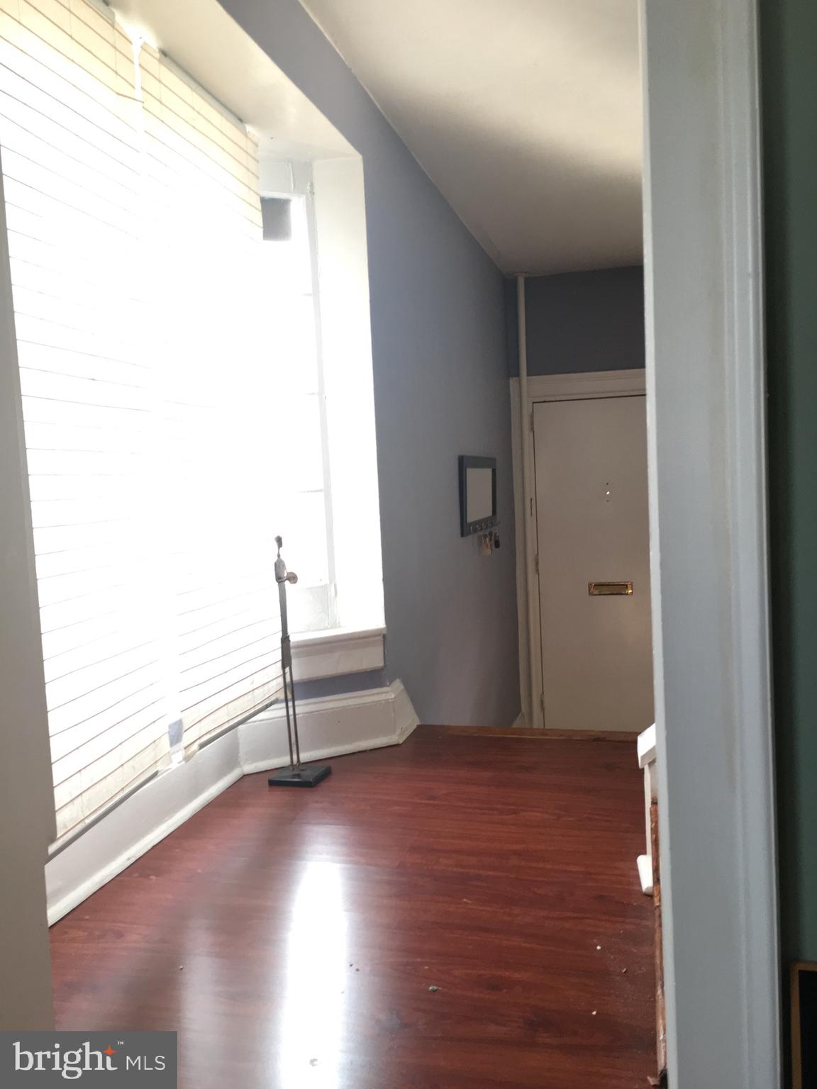 3704 Chatham Road Baltimore, MD 21215 - Photo 4 of 28 an empty room with wooden floor and windows