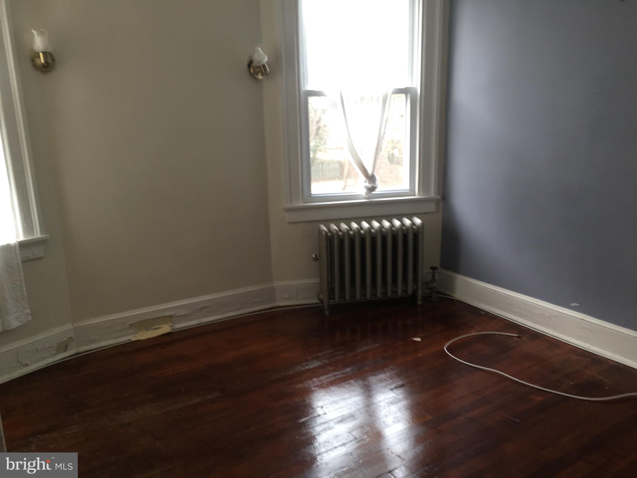 3704 Chatham Road Baltimore, MD 21215 - Photo 9 of 28 an empty room with wooden floor and windows