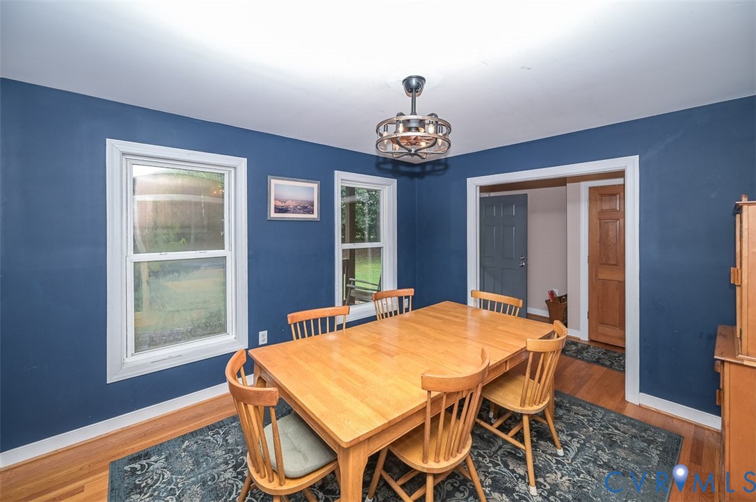 Hardwood flooring, painted walls, two windows, and