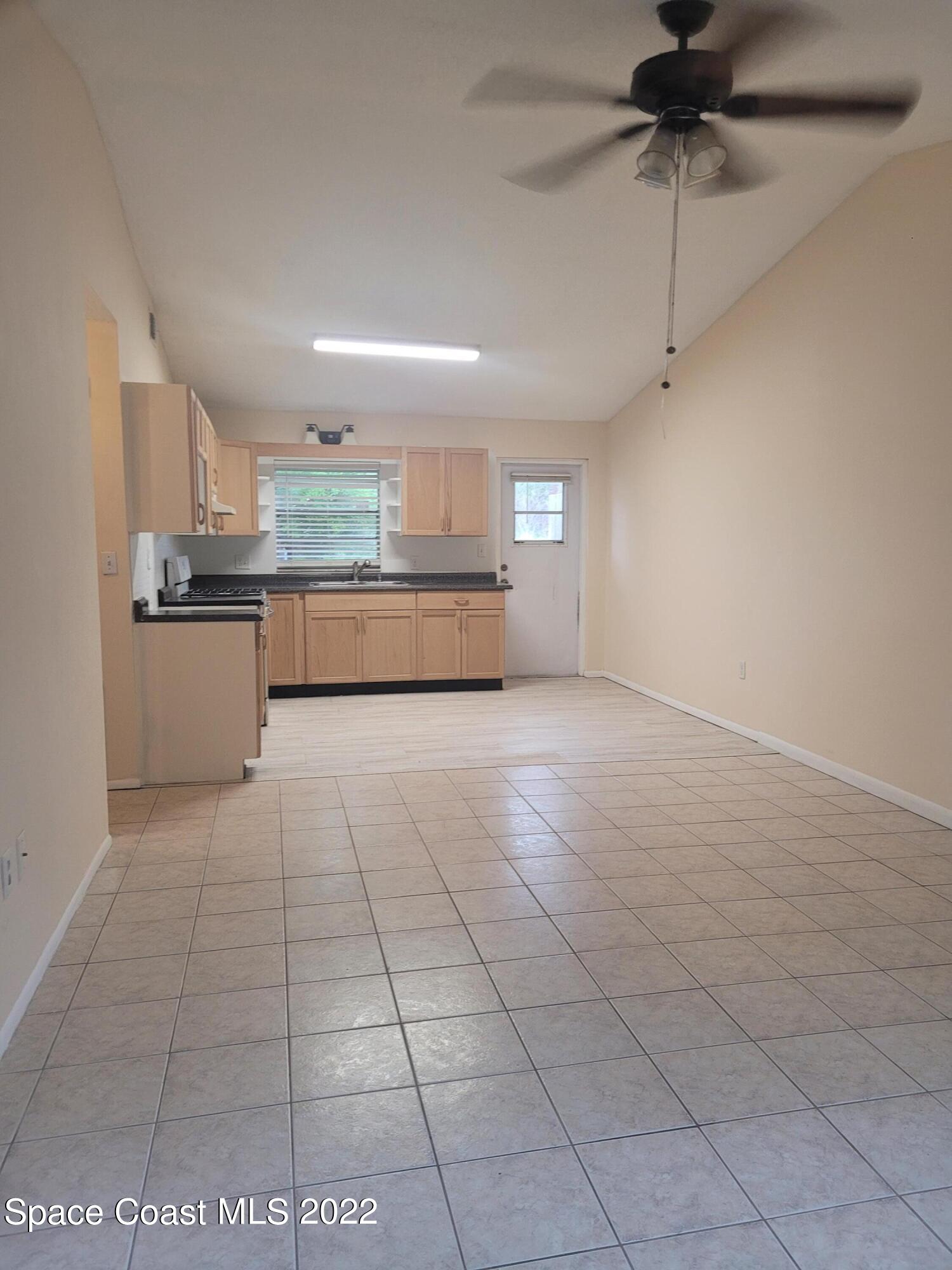 3225 Murrell Road, Unit 7 Rockledge, FL 32955 - Photo 2 of 9 a large kitchen with cabinets and a stove