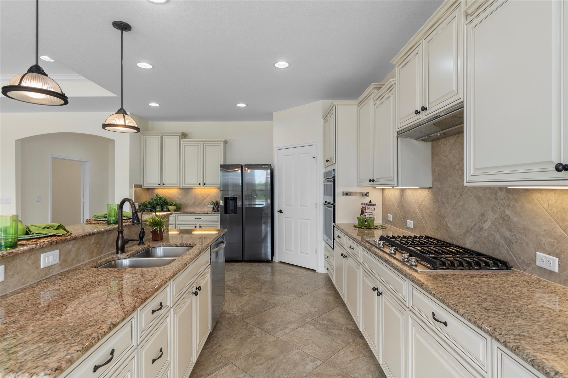 205 McKittrick Ridge Road Georgetown, TX 78633 - Photo 12 of 37 a kitchen with stainless steel appliances granite countertop a sink stove and refrigerator