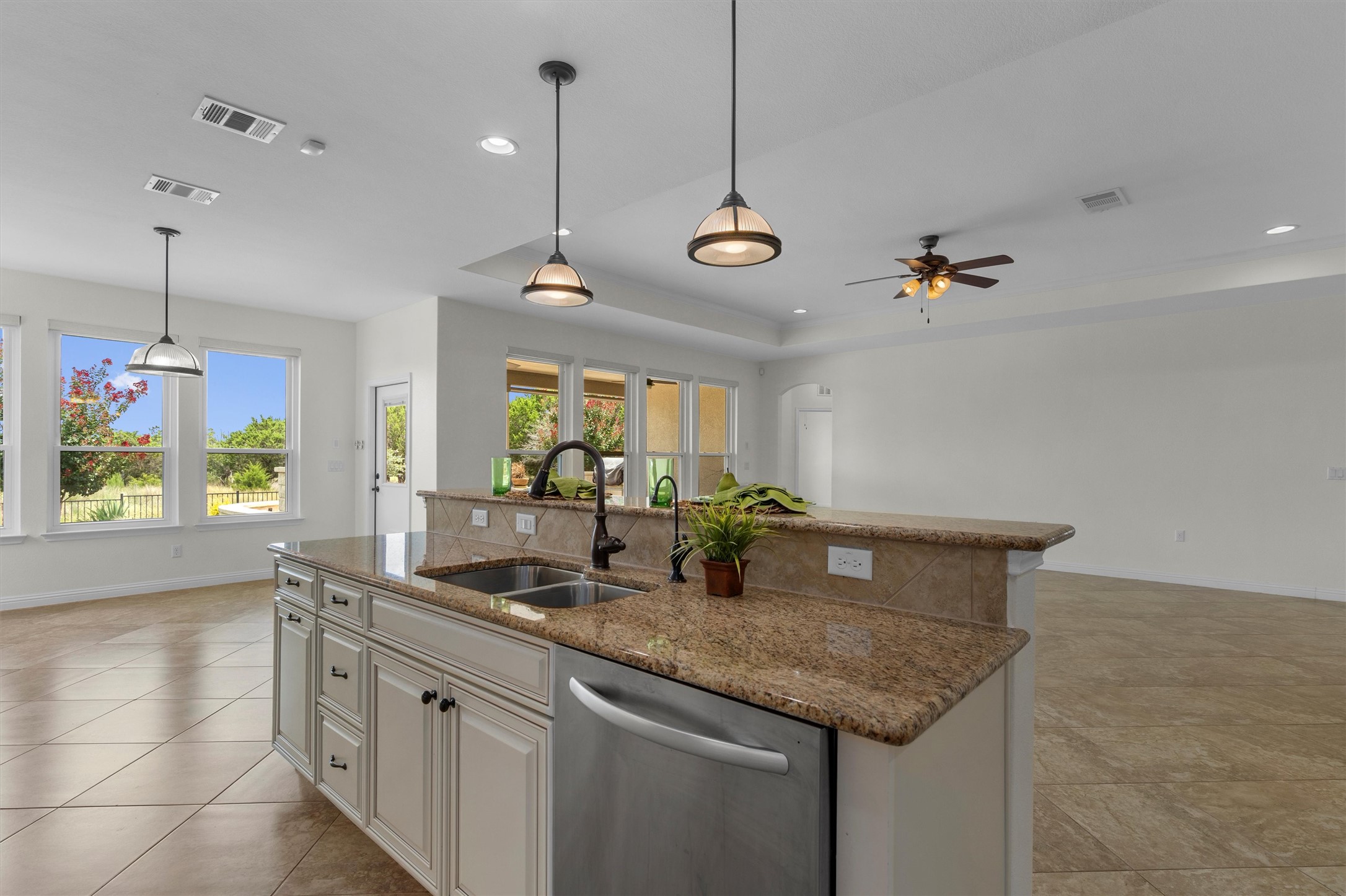 205 McKittrick Ridge Road Georgetown, TX 78633 - Photo 14 of 37 a kitchen with kitchen island granite countertop a sink a stove and a chandelier
