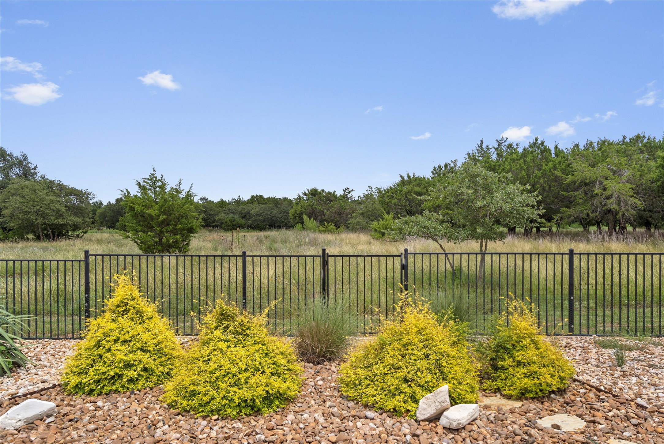 205 McKittrick Ridge Road Georgetown, TX 78633 - Photo 32 of 37 a view of a lake with wooden floor and fence