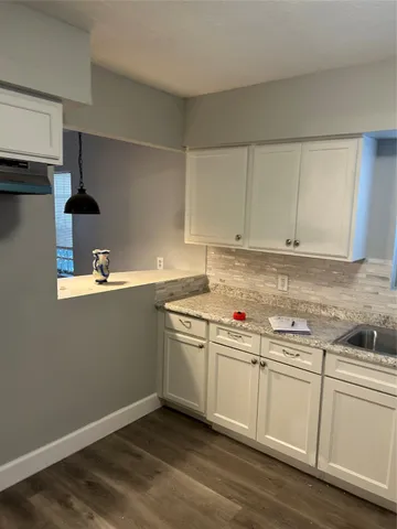 a kitchen with stainless steel appliances granite countertop a sink and a stove