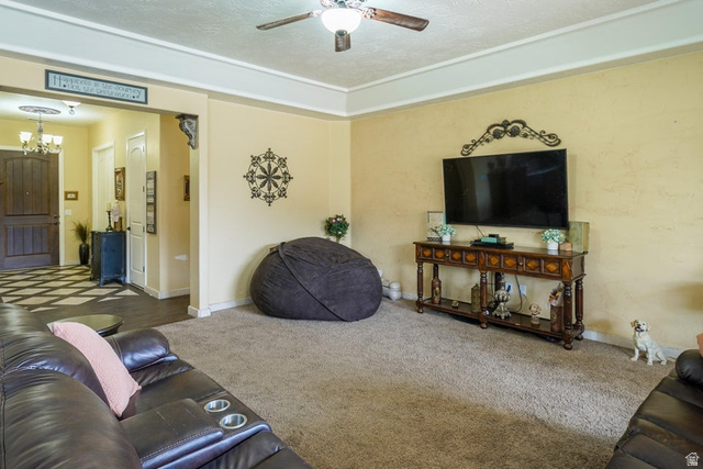 3683 South 2640 West St. George, UT 84790 - Photo 22 of 41 Living area featuring carpet flooring, crown molding, and a ceiling fan with integrated lighting