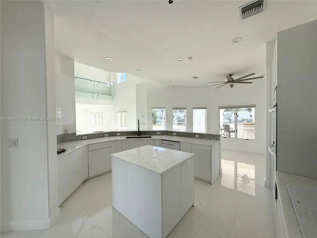 a kitchen with granite countertop cabinets a sink and appliances