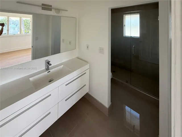 a bathroom with a double vanity sink a and mirror