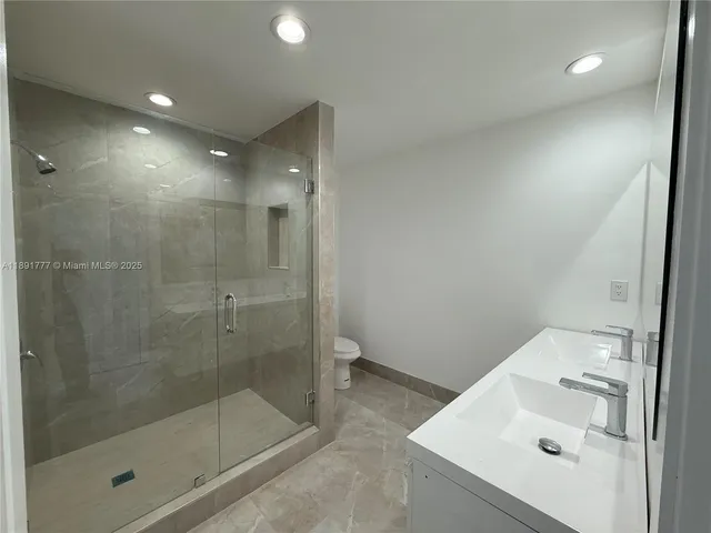 a bathroom with a shower and sink