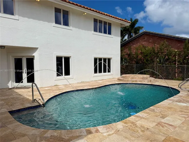 a view of a house with backyard and sitting area