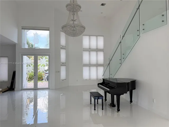 a living room with furniture and a chandelier