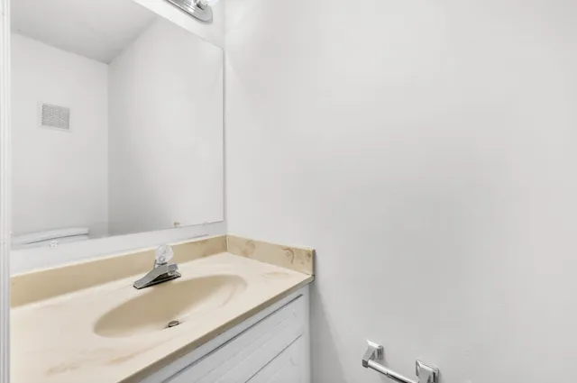 a kitchen with a refrigerator stove and white cabinets