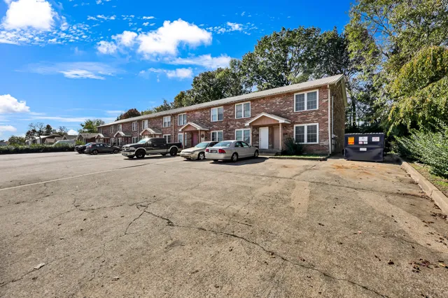 a view of a house with a yard and sitting area