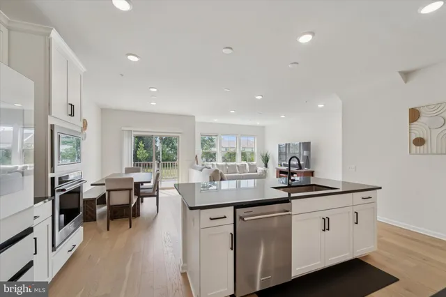 a kitchen with counter space sink and living room